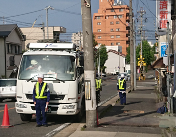 Zone officers managing traffic near a truck on a city street